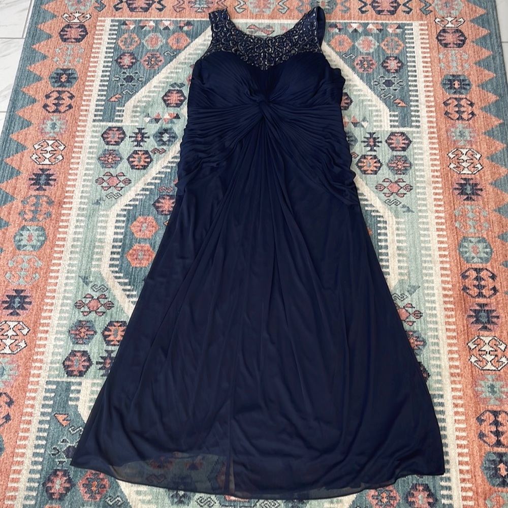 Plus size navy gown with hand beaded neckline.